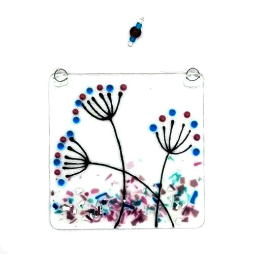 Fused glass suncatcher featuring flowers in spring, available at Cerulean Arts.