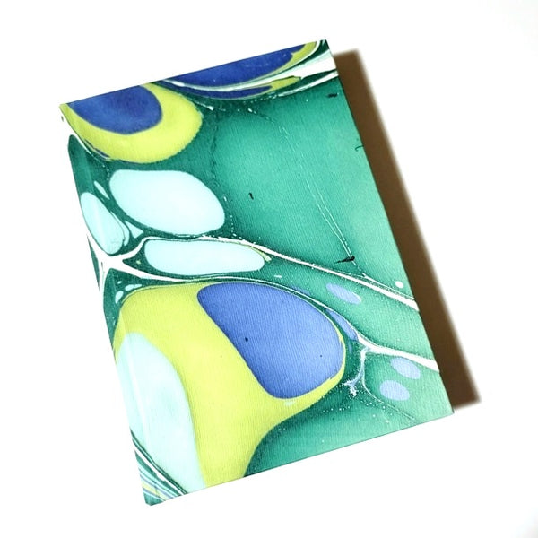 Hardcover journal with marble design in blues and greens, available at Cerulean Arts.