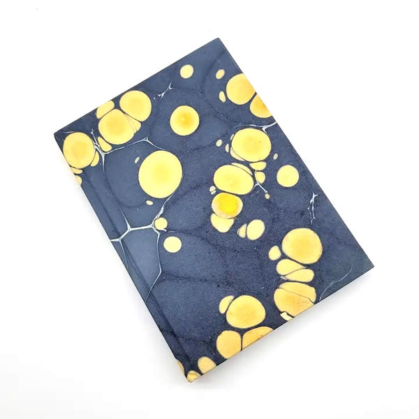 Hardcover journal with marble design in slate and gold, available at Cerulean Arts.