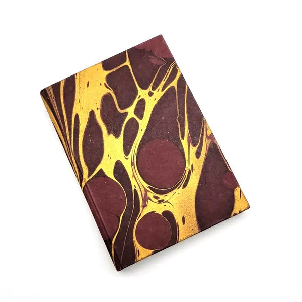 Hardcover journal with marble design in burgundy and gold, available at Cerulean Arts.