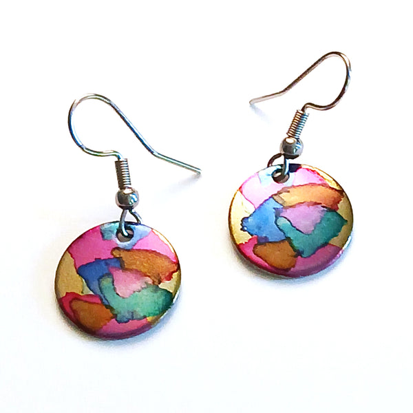Stainless steel circle earrings hand painted with alcohol ink in pink shades, available at Cerulean Arts.