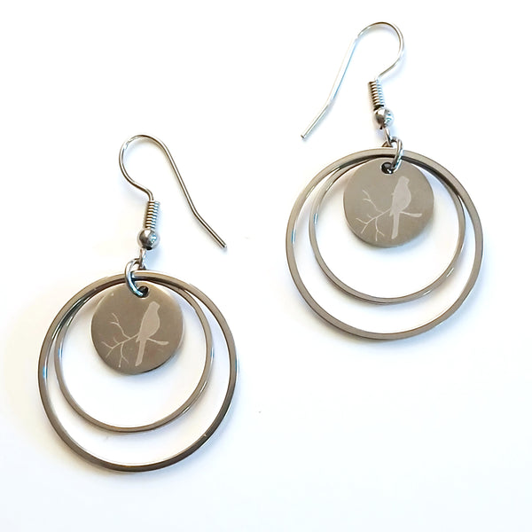 Stainless steel double hoop earrings with etched birds, available at Cerulean Arts.