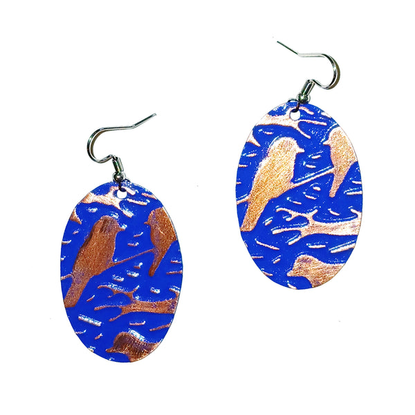 Oval-shaped earrings with blue and copper bird design 