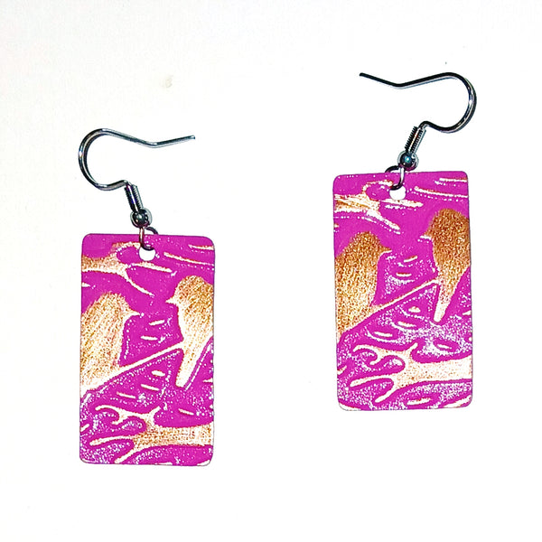 Rectangular earrings with copper bird design on a pink background