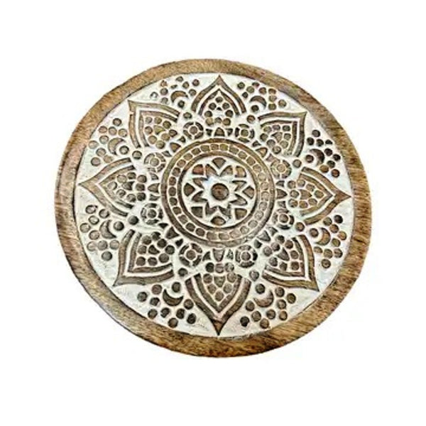 Carved mango wood trivet with white-washed mandala design, available at Cerulean Arts.