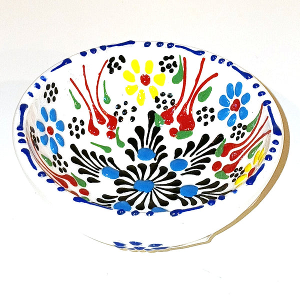 Decorative ceramic bowl with colorful abstract patterns on a white background