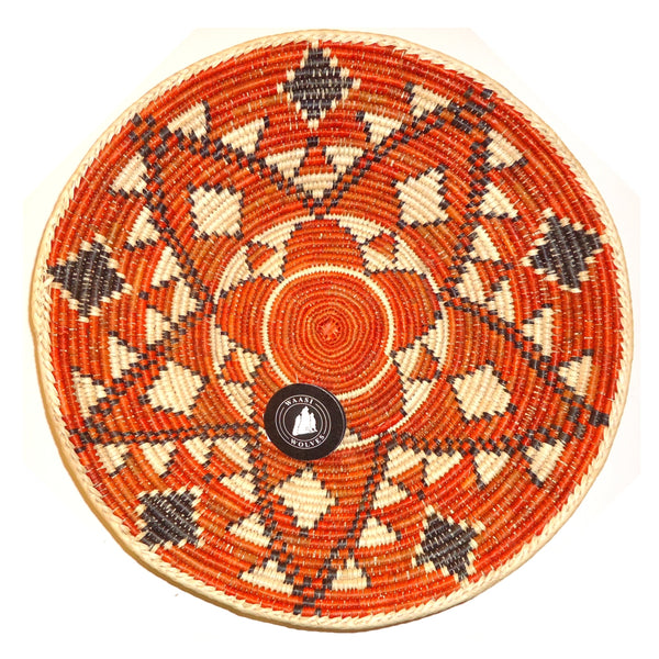 Decorative woven basket with geometric starburst pattern in orange.