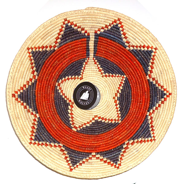 Decorative woven basket with blue and orange ceremonial pattern.