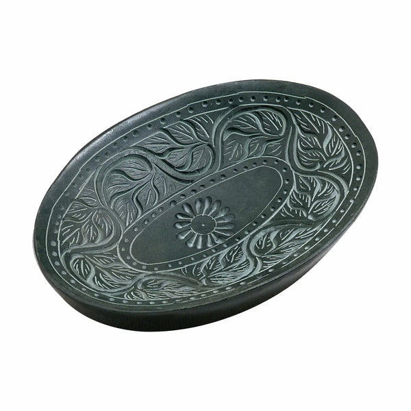 An oval dark green soap dish with embossed floral and leaf patterns, shown on a plain white background.