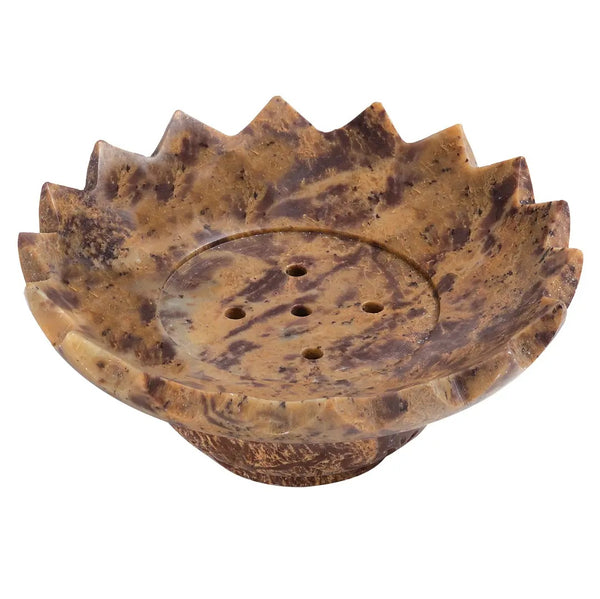 A decorative stone soap dish with a lotus-shaped scalloped rim and a central drainage hole, featuring a mottled brown and tan stone pattern.