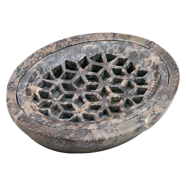 Carved soapstone soap dish with geometric design.