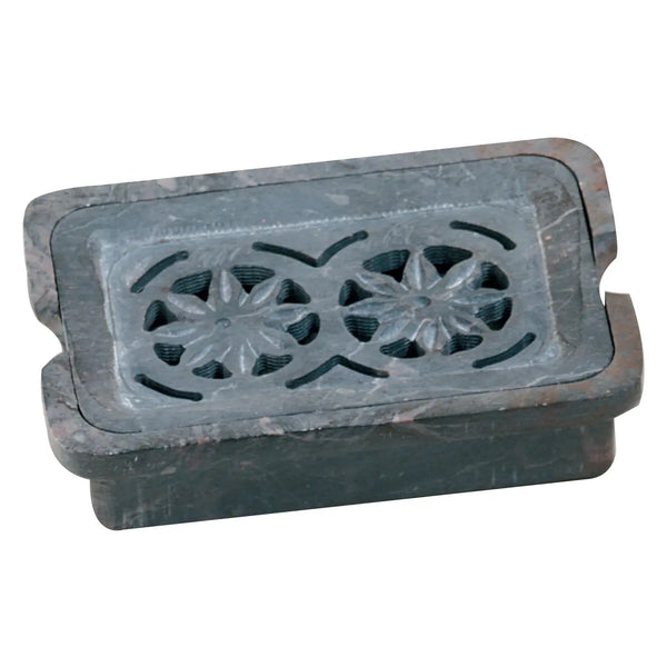 A rectangular dark gray stone soap dish with two circular floral cutouts and decorative curved accents, shown on a plain white background.