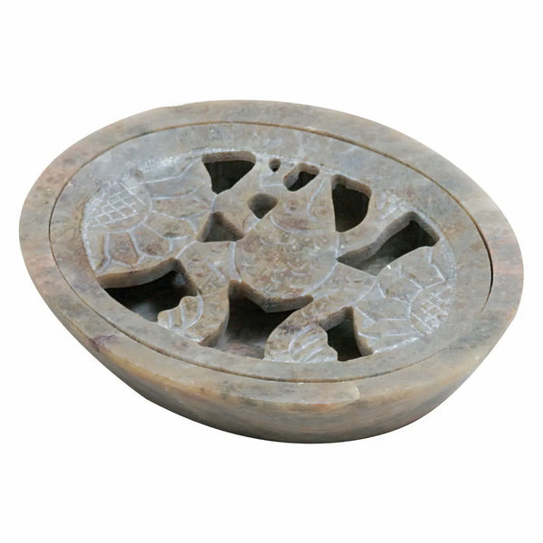 An oval soap dish with a carved lid featuring a central frog figure and surrounding geometric patterns, shown on a plain white background.