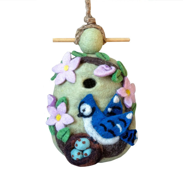 Decorative felt birdhouse with a nesting blue jay and flowers.