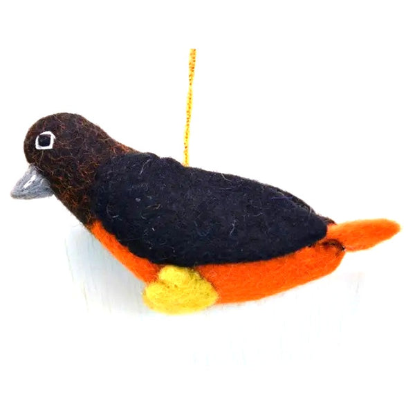 Felted bird ornament with black, orange, and yellow colors.