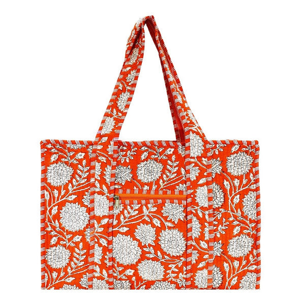 Orange tote bag with white floral pattern.