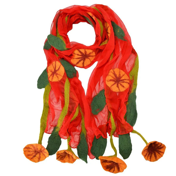 A vibrant red sheer scarf decorated with felted orange flowers and green leaves, featuring dangling felted flower tassels at the bottom.