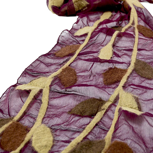 Close-up of a fabric with leaf patterns in maroon and beige