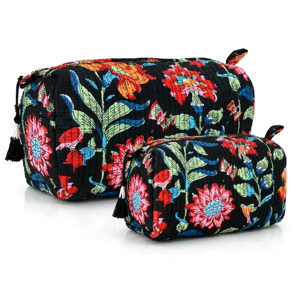 Two quilted cosmetic pouches with a vibrant floral print on a black background.
