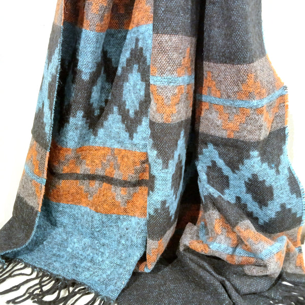 Patterned scarf with blue, orange, and gray colors.