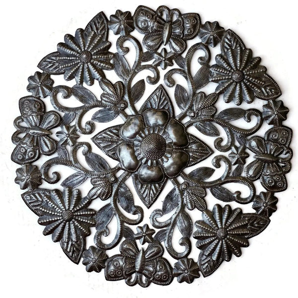 An ornate circular metal wall hanging with embossed butterflies amidst floral and scroll motifs