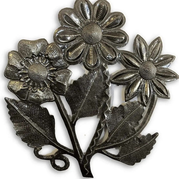 Three-dimensional metal wall decor featuring three textured daisy flowers and leaves in a dark silver finish.