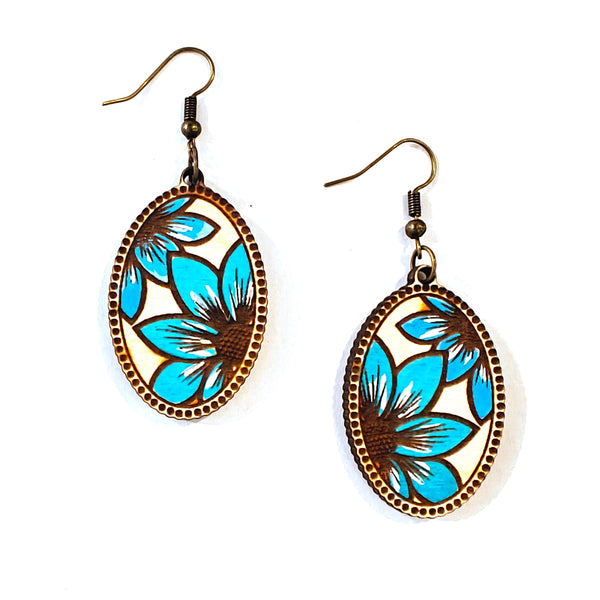 A pair of oval dangle earrings with turquoise blue and brown floral designs set in a bronze-tone metal frame, shown on a plain white background.