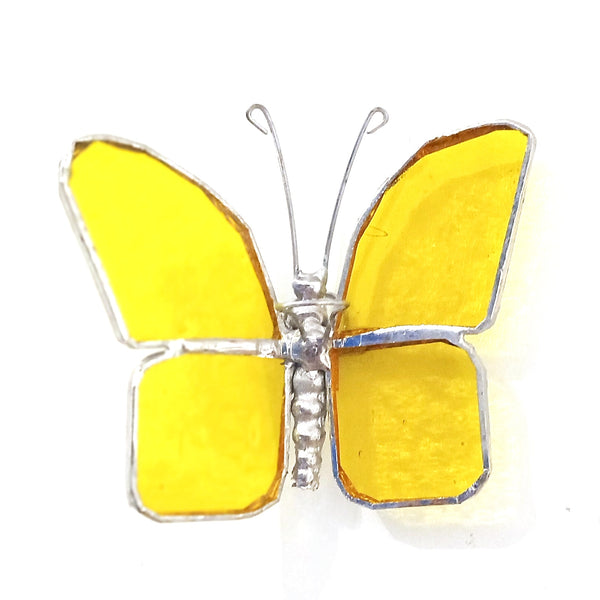 A butterfly-shaped hanging stained glass featuring bright yellow glass panels set in silver-tone metal, with delicate wire antennae.
