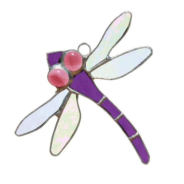 Stained glass dragonfly in purple with pink eyes.