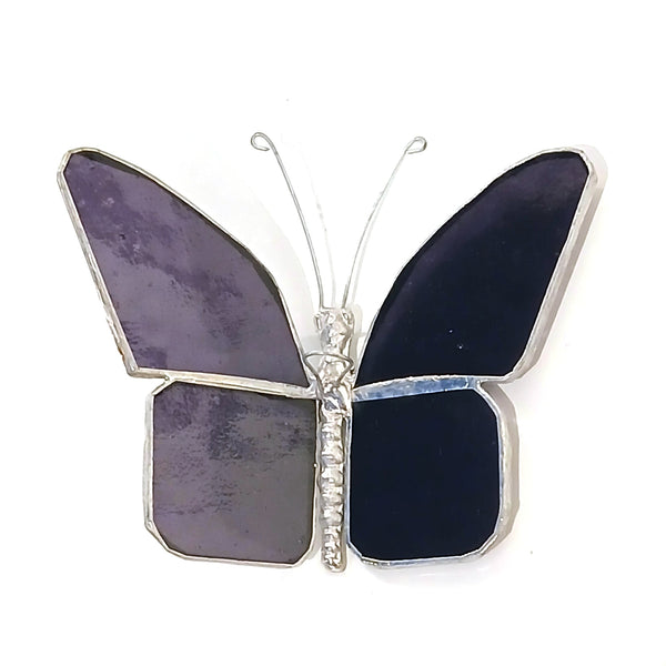 A butterfly-shaped hanging stained glass featuring four wings in shades of purple set in silver-tone metal.