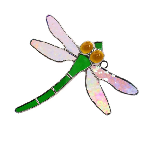 Stained glass dragonfly in green with yellow eyes.
