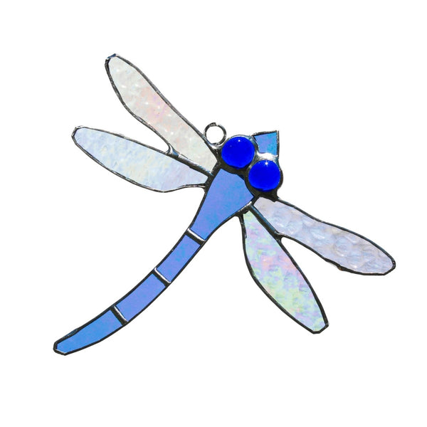Stained glass dragonfly in pale blue with bright blue eyes.