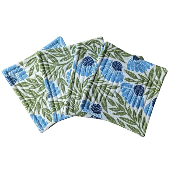 Quilted fabric coaster set with blue echinacea pattern.