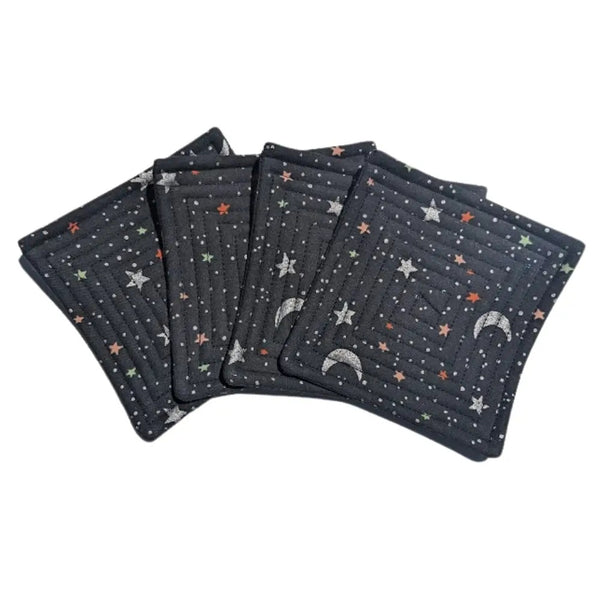 Quilted fabric coaster set with black night sky and stars pattern.