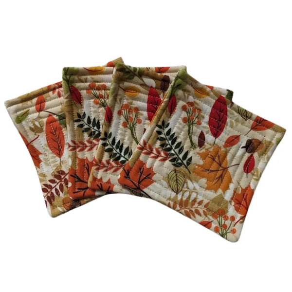 Quilted fabric coaster set with autumn leaves pattern.