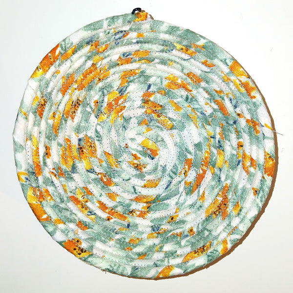 Fabric bowl in orange and green colors.