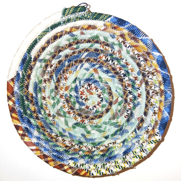 Fabric bowl with mixed plaid prints in multiple colors.