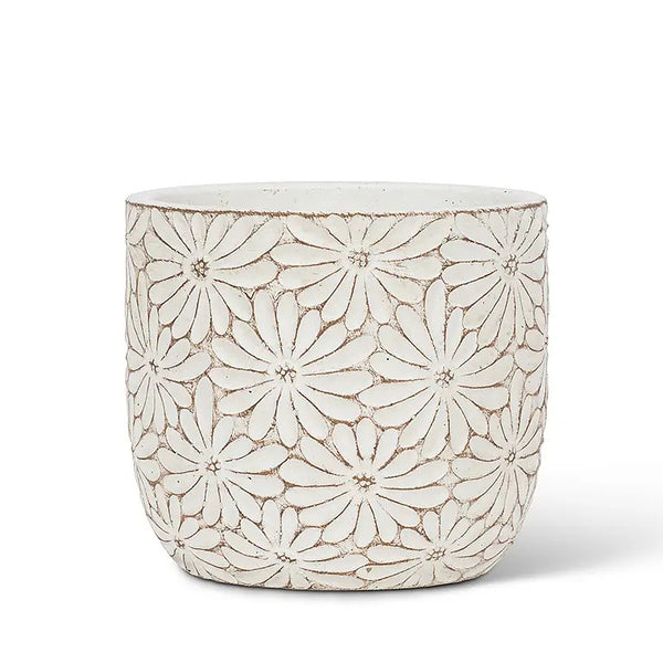 Round cement planter with white sculpted daisy design.