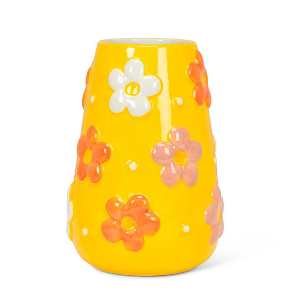 Bright yellow ceramic vase with raised flower design in white and orange.