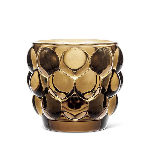 Brown glass votive holder with bubble pattern.