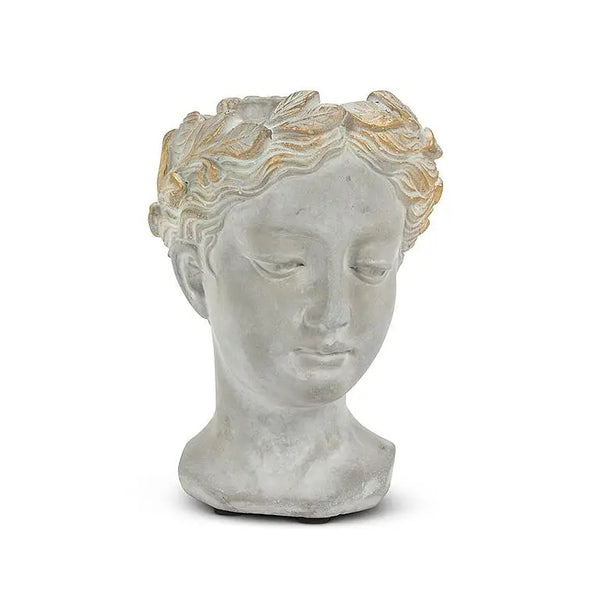 Woman's head planter made of gray cement with gold colored crown.