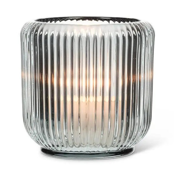 Gray glass votive holder with ribbed texture.