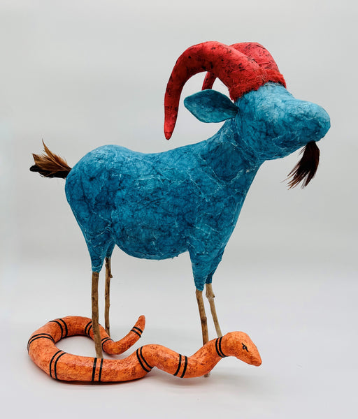 Blue goat with red horns and orange snake 
