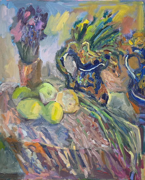 An expressive still life painting featuring green mangoes, a blue patterned pitcher filled with leafy greens, and a bouquet of purple flowers on a tablecloth-covered surface, rendered in bold impasto brushstrokes.