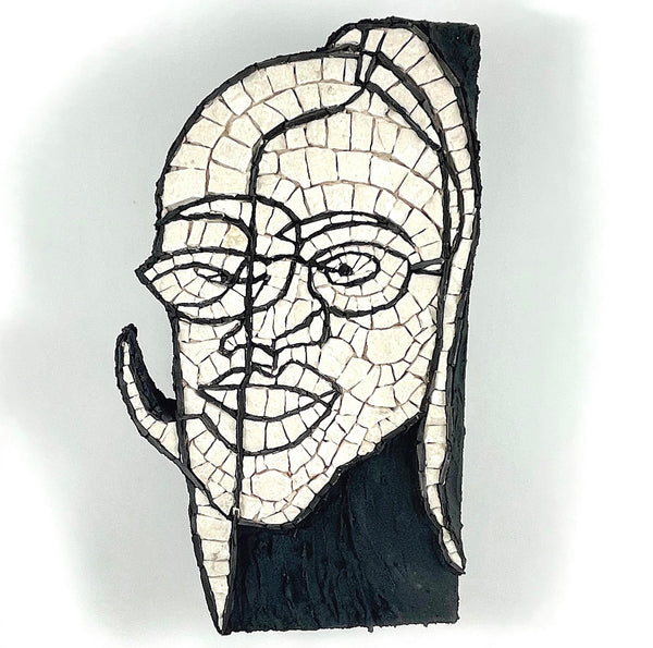 A mosaic wall art piece depicting a stylized human face in profile, made from off-white rectangular tiles outlined in black.