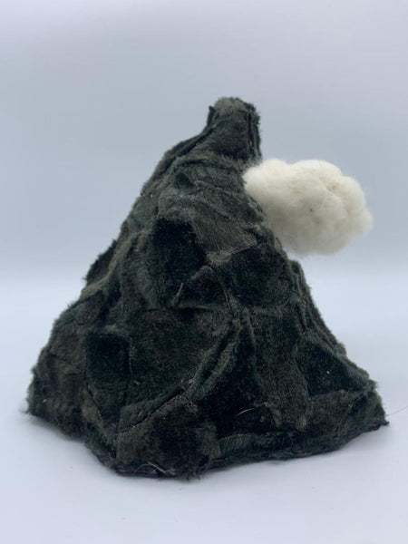 A miniature dark green textured volcano with a small white cloud accessory, photographed on a light gray background.