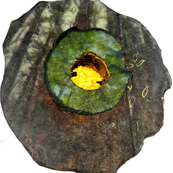 Abstract encaustic painting with a central yellow circle surrounded by green and brown colors in an organic shape