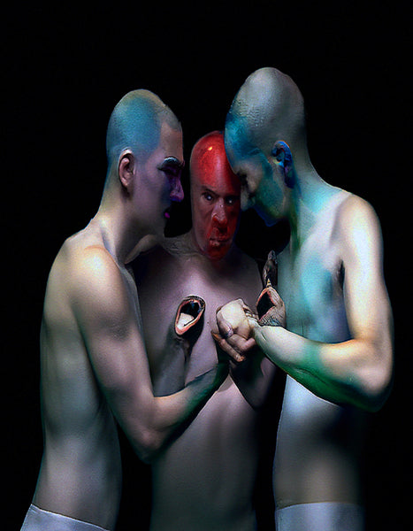 Digital print of three shirtless men with colorful body paint holding their hands together between them