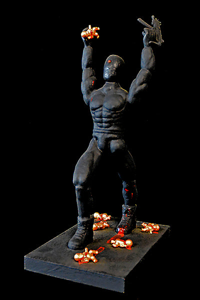 Sculpture of a muscular figure with raised arms on a black platform against a dark background