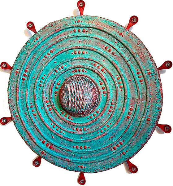 Decorative circular wall art with concentric patterns and red accents 